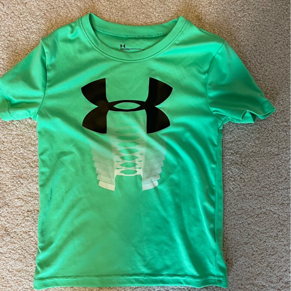 Green Under Armour shirt. Boys size 5. Played in but life left.